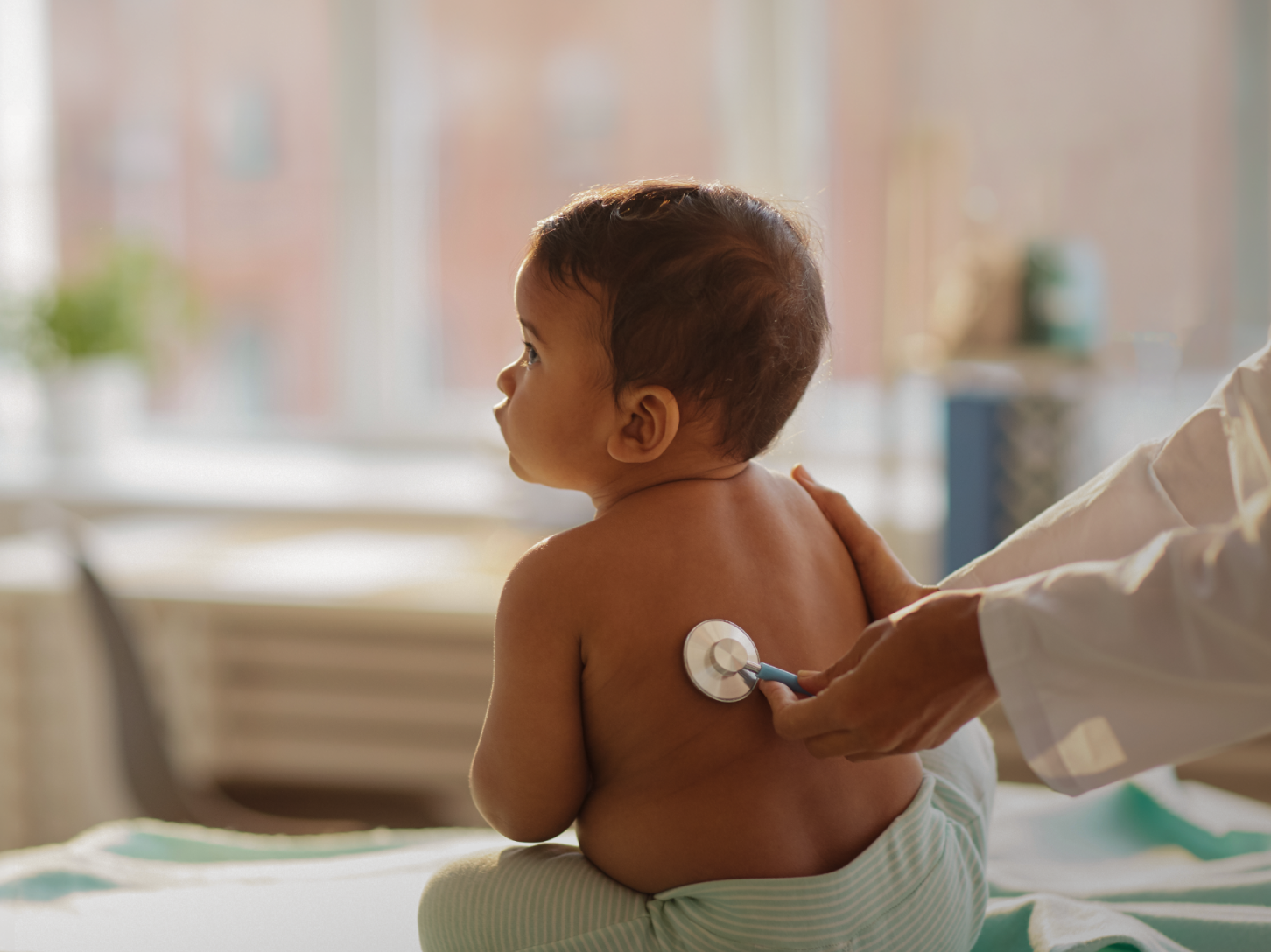 A baby being examined with a stethoscope